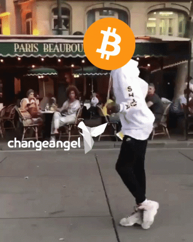 a man in white shirt doing a trick with a bitcoin over his head