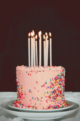 a cake with frosting and decorated with candles