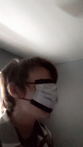 person wearing medical face mask in a room