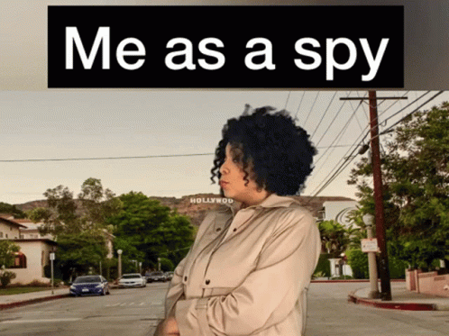 the woman is standing under a black sign with a word that says me as a spy