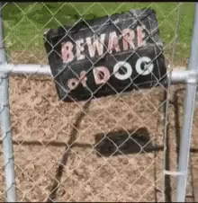 a metal fence behind a fence with a sign attached