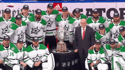 a po with a group picture of hockey players, as well as one trophy