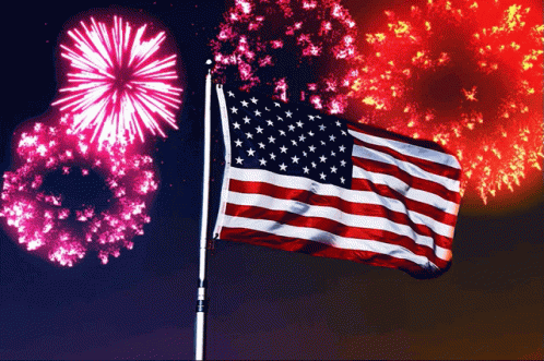 a big fireworks show with a giant flag and fireworks