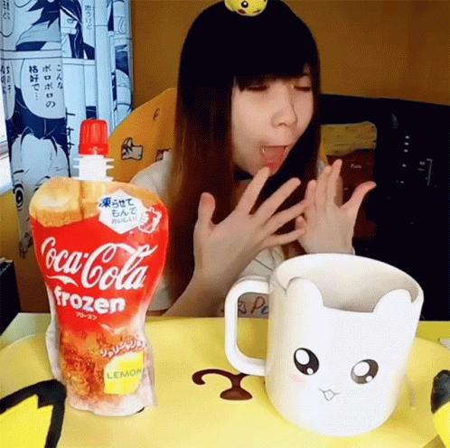 a woman at a table with a cup of coke and an animal shaped pitcher