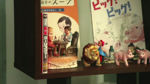 small children's dolls on display beside books