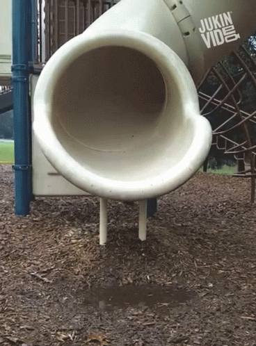 a huge white pipe is sitting on a small stand
