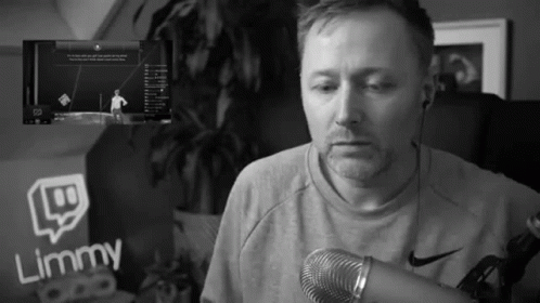 a man speaking into a microphone in a living room