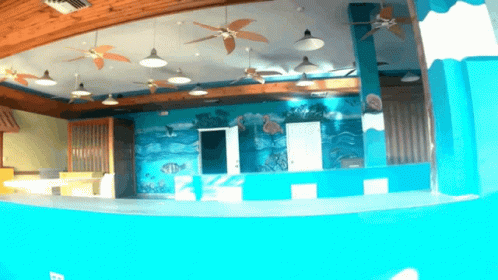 there is a blue and yellow indoor swimming pool