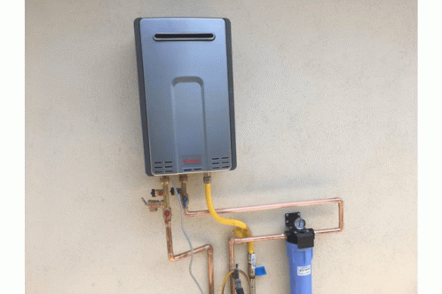 a tankless water heater mounted to the side of a wall