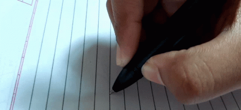 a hand is holding a pen on a paper