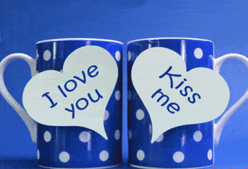 two red hearts that are on a coffee mug