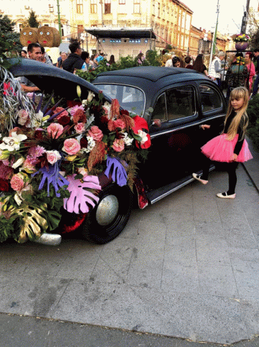 a car decorated with fake flowers and leaves