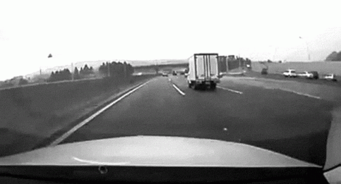 the camera shows trucks from inside of a vehicle