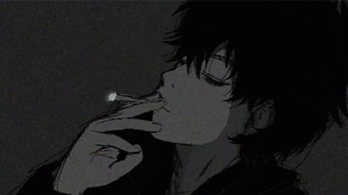 a boy in the dark smoking a cigarette