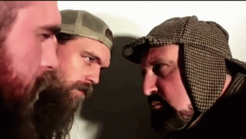 two men with beards looking at each other