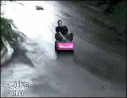 a person on a toy car driving down the street