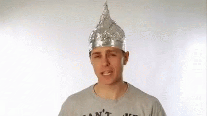 a person wearing a blue shirt has a silver crown