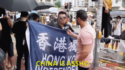 an asian man holding up a sign with words in chinese