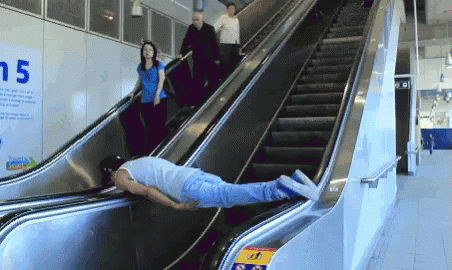 two people with one on an escalator looking for things to eat