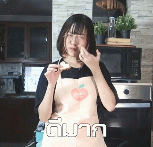 a woman wearing an apron making a silly face