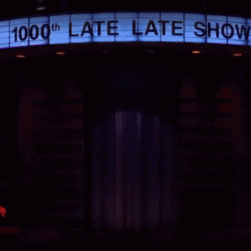 a lit up theatre sign is shown in the dark