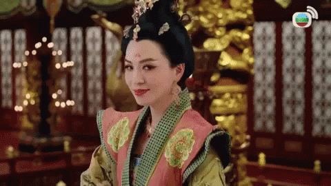 an asian woman dressed in green and blue