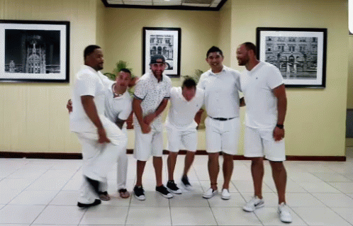 a group of men in white shirts and black shoes