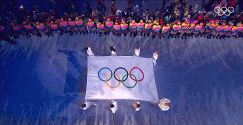 a white sheet with olympic symbols is on top of a floor