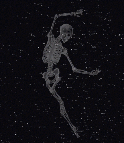 a black and white image of a skeleton that is in the dark