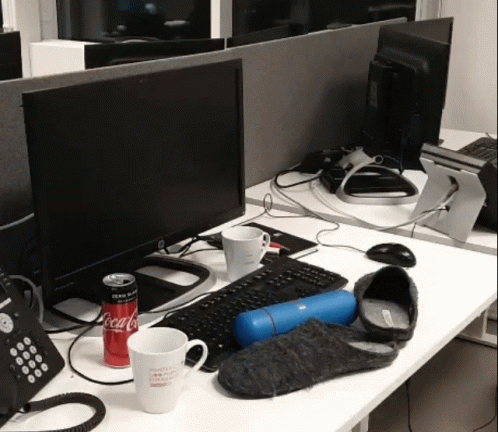 a table topped with a keyboard and a monitor