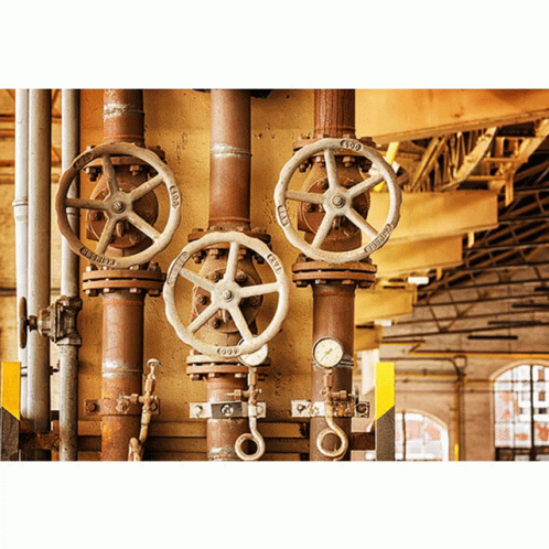 some valve valves in an industrial setting near a building