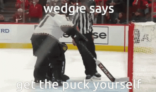 a person is on the ice about to hit a hockey pucker