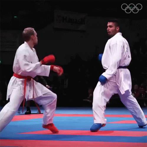 two men are competing in an amateur karate competition
