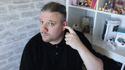 man looking at the camera while brushing his hair