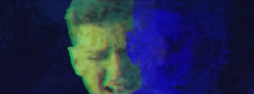 a multi - color abstract painting of a man's face