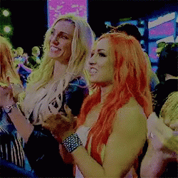 two blondes are standing around in the crowd