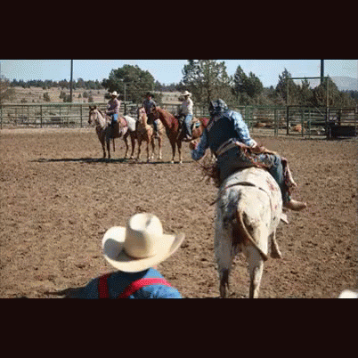 men in cowboy outfits riding on horses