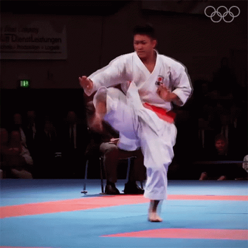 a man with a white kimono doing karate