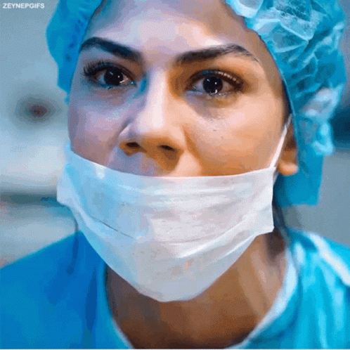 a woman with surgical mask and yellow cap
