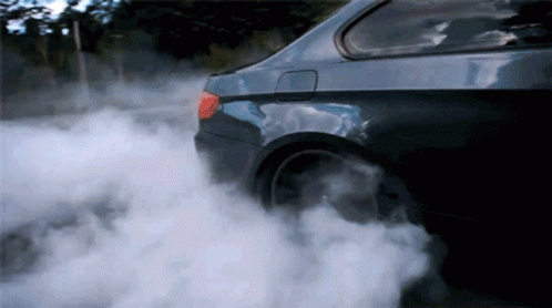 the smoke comes from the car which is driving away