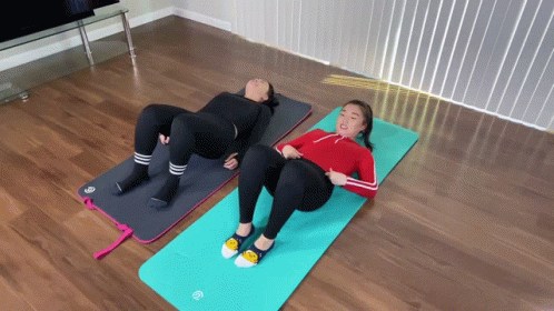 three women are exercising on exercise mats
