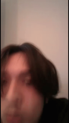 a blurry image of a man making an odd face