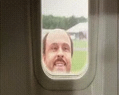 a man's face is looking through a window