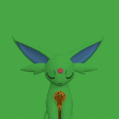 a little green animal with its eyes closed and a microphone in the mouth