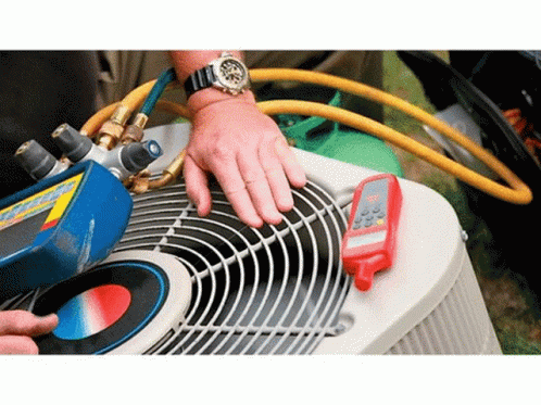 a person wearing gloves and blue rubber gloves cleaning an air conditioner