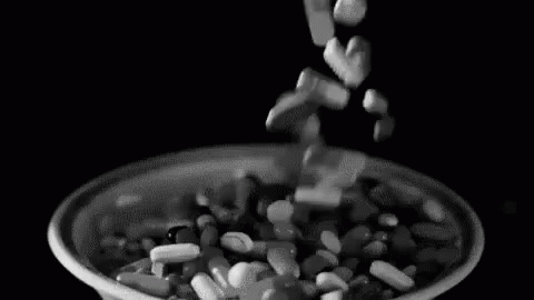 a black and white image of scattered cereal in a bowl