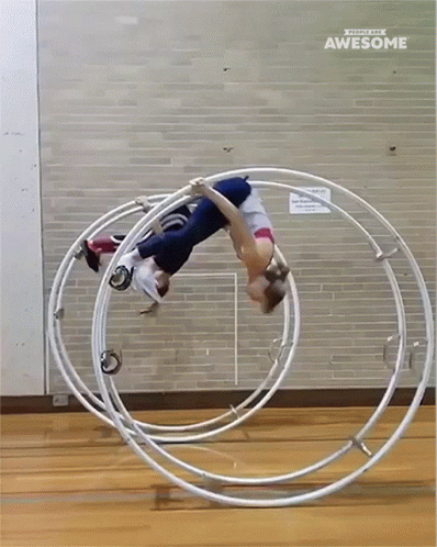 a man doing aerial acrobatics in a gym