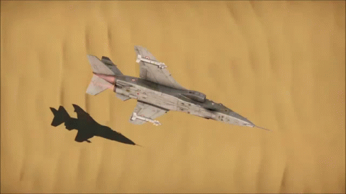 two jet fighters in the air while one is flying with a camouflage jet over his head