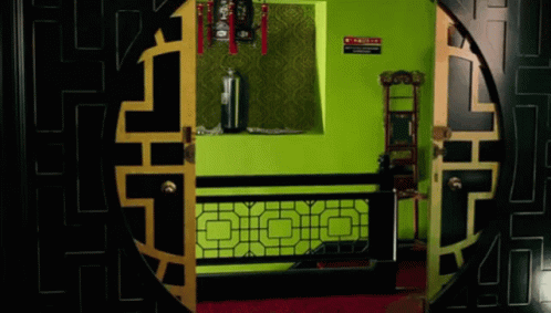 the door is very large and a room with green and black walls
