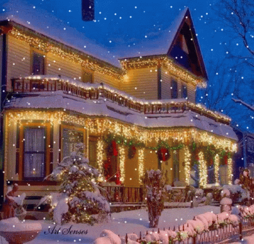 a winter scene with snow and holiday lights on a large house
